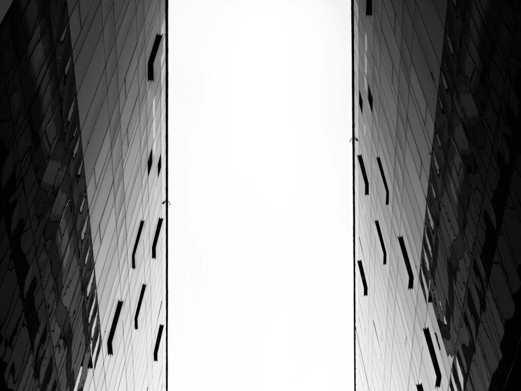 a black and white photo of two tall buildings