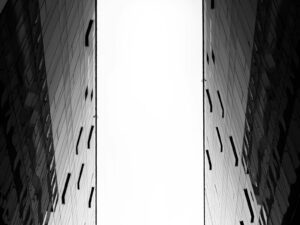 a black and white photo of two tall buildings